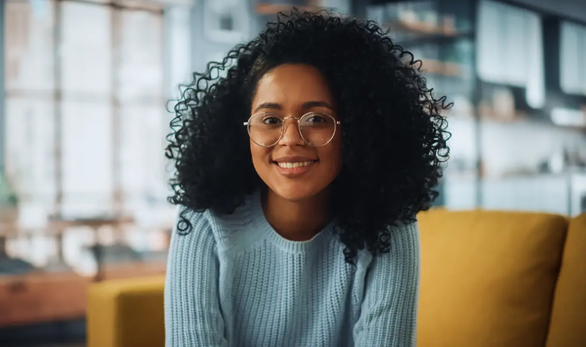 young african american woman wearing glasses and smiling