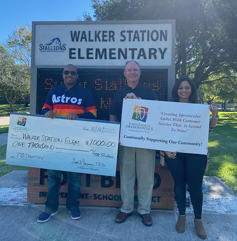 Dr. Harmon donates $1000 to Walker Station Elementary School