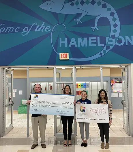 Dr. Harmon donates $1000 to Cornerstone Elementary School